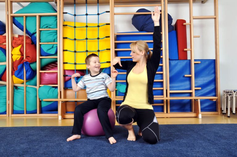 young boy plays with medicine ball with Childrens And Teens Therapy Services therapist
